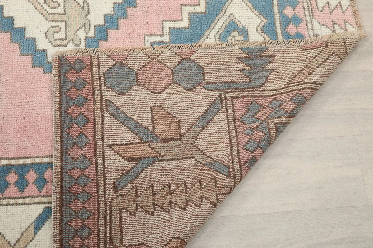Another view of the rug's reverse side, showing the intricate backing and construction