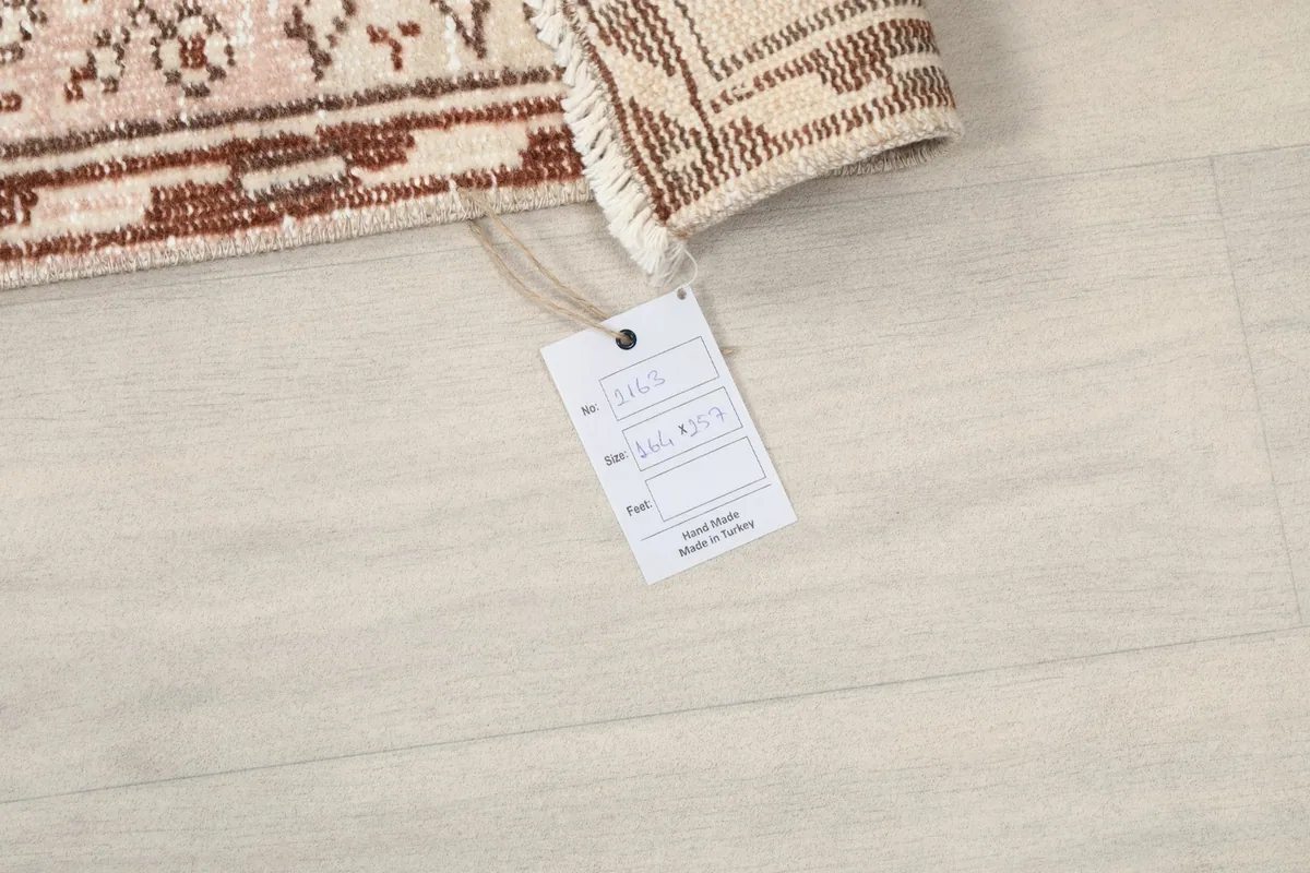 Close-up of the RugsKilim tag attached to the vintage Anatolian rug