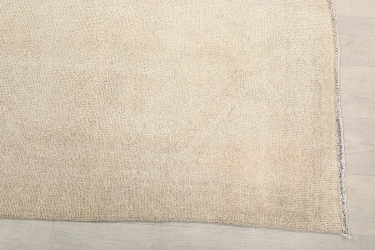 Detailed view of the rug's surface, showing the low pile and the natural patina of the vintage wool.