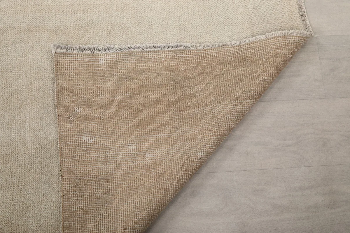 Close-up of the rug's back, showing the consistent knotting and the sturdy cotton foundation.