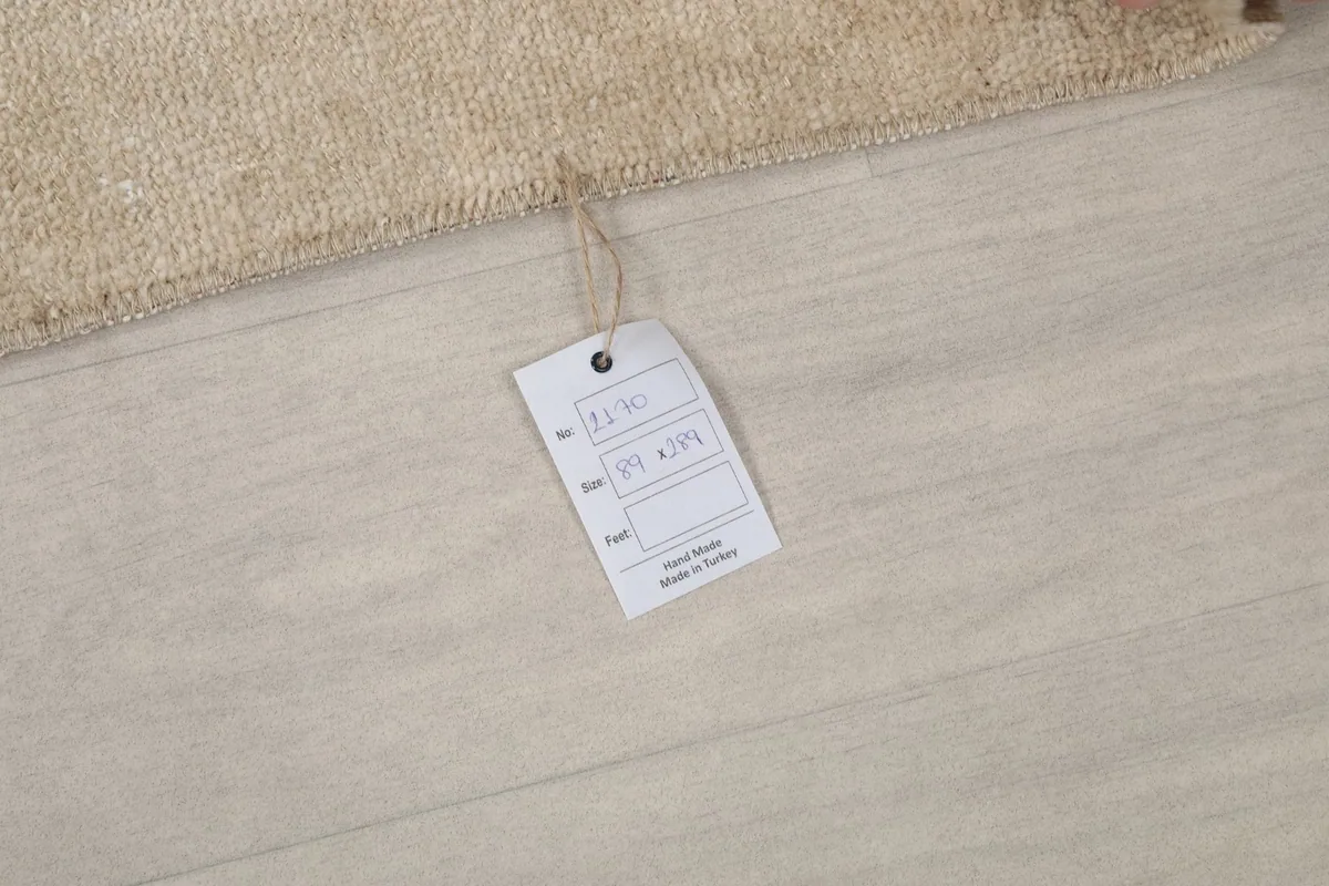 Product tag attached to the rug, displaying information such as item number and origin.