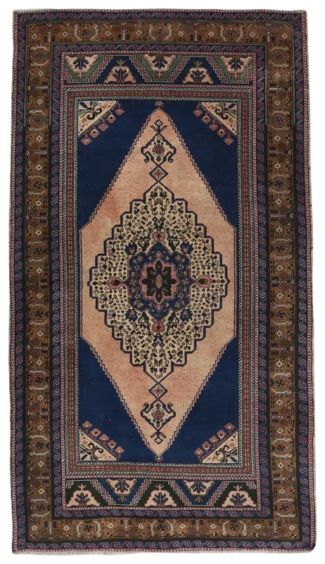Full overhead view of the navy and beige vintage Anatolian rug on a white background