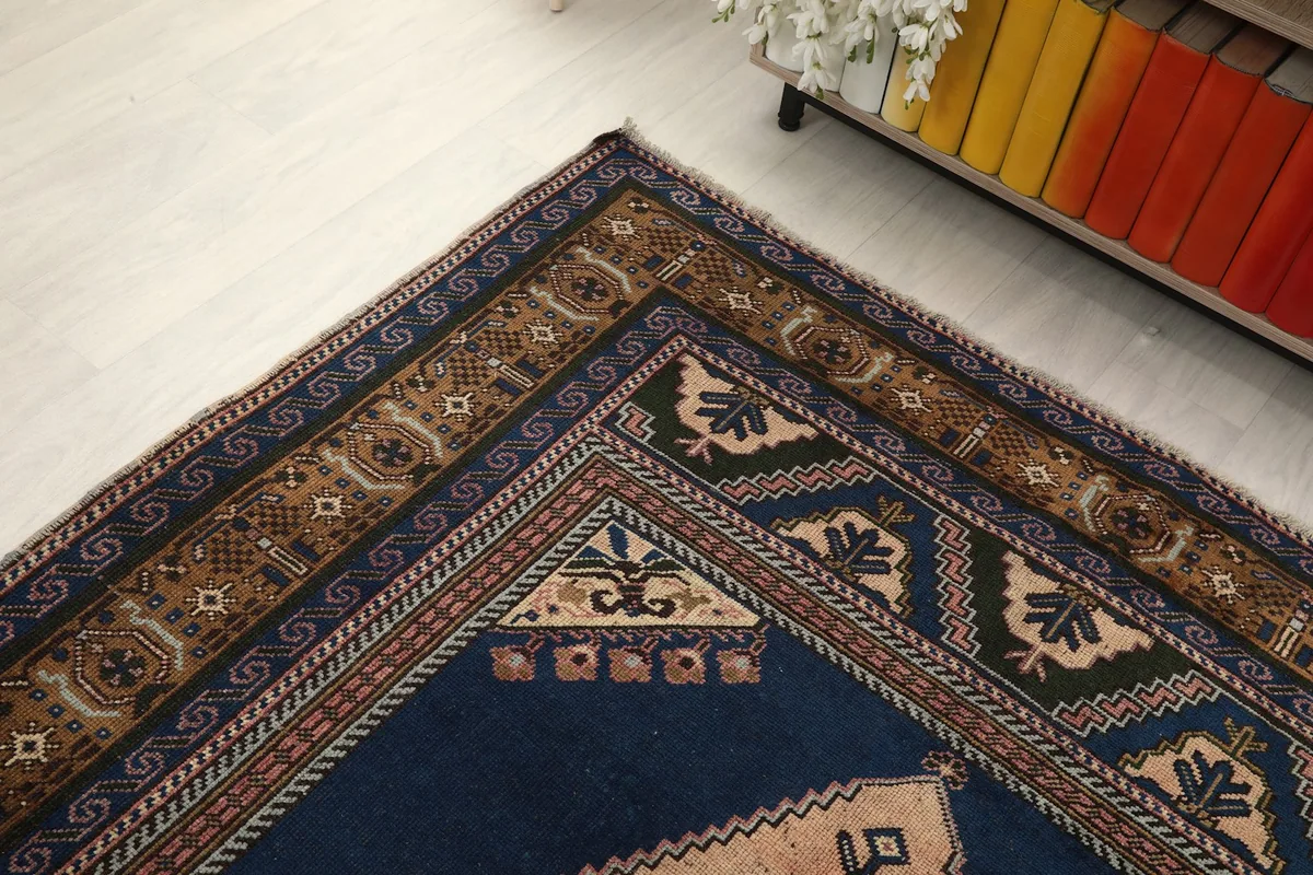 High-angle shot of a rug corner, emphasizing the distinct border layers and color variations