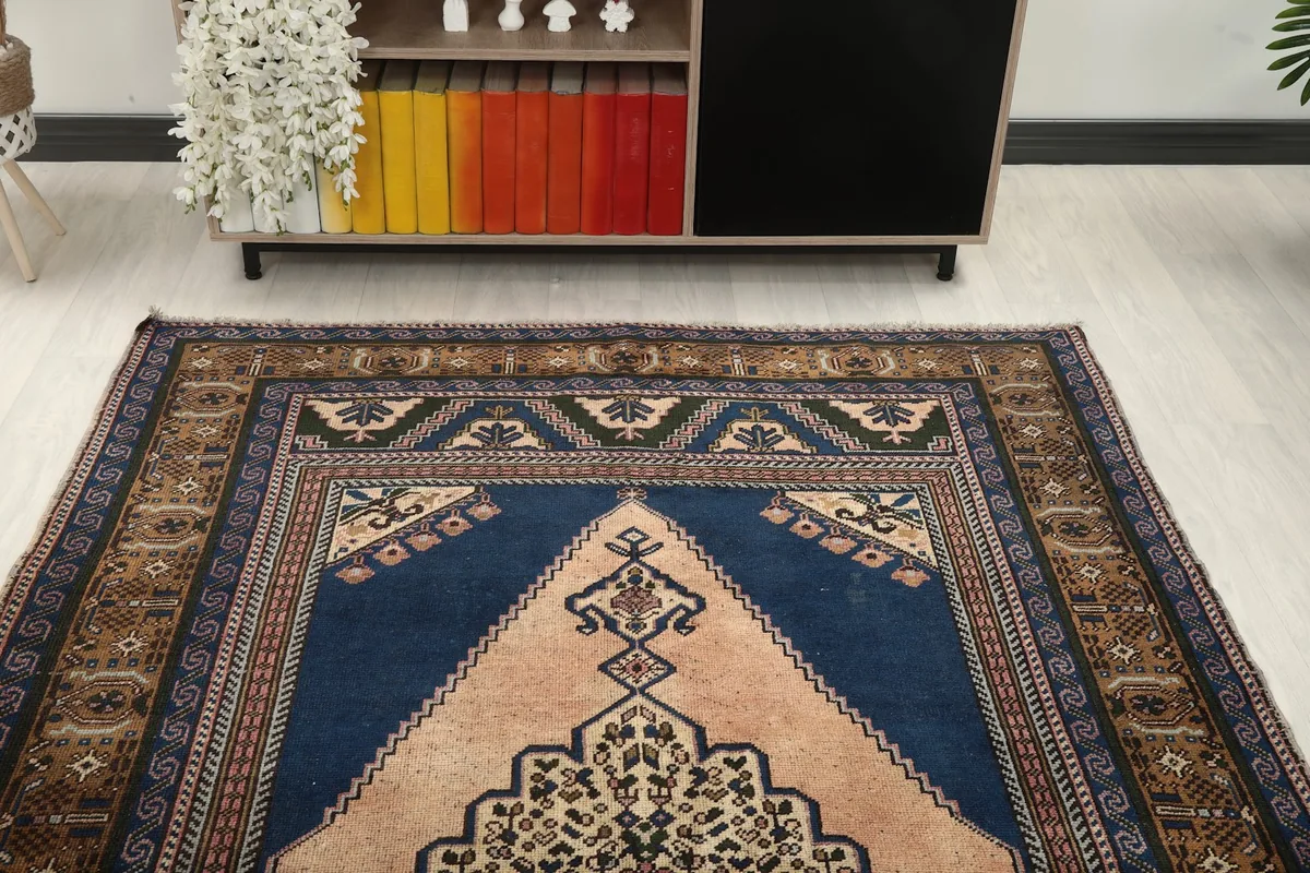 Overhead view focusing on the upper half of the rug, showing the medallion and surrounding patterns