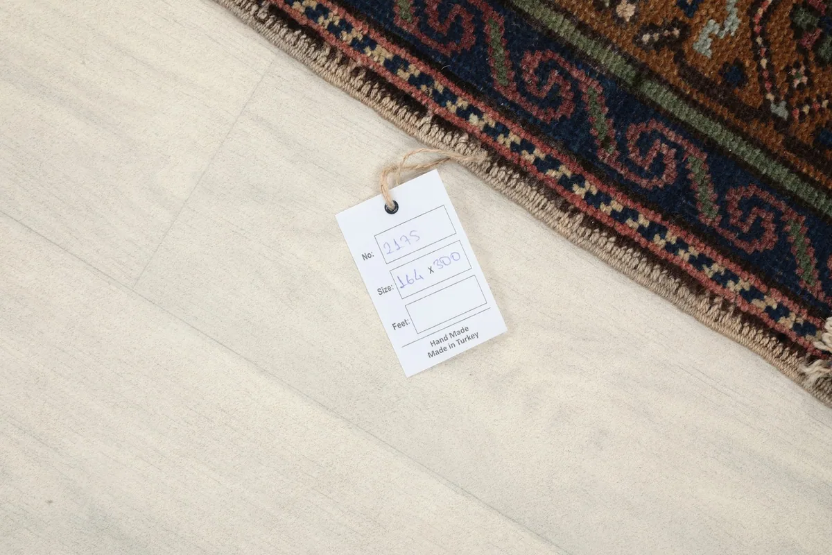 Close-up of the rug's edge with a product tag, indicating its origin and dimensions