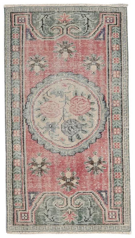 Full overhead view of the vintage rose and green floral medallion area rug
