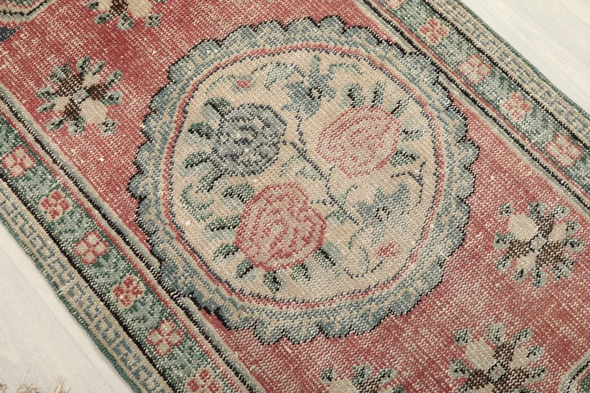 Close-up of the central ivory floral medallion with rose and blue motifs