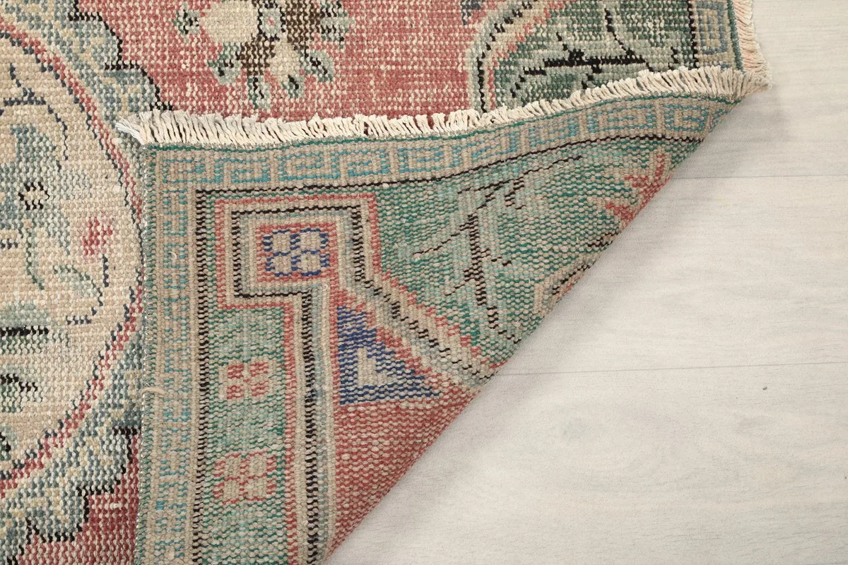 Underside of the rug's corner, showing the tightly woven cotton foundation