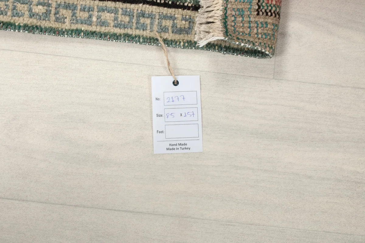Product tag attached to the rug, displaying origin and size information