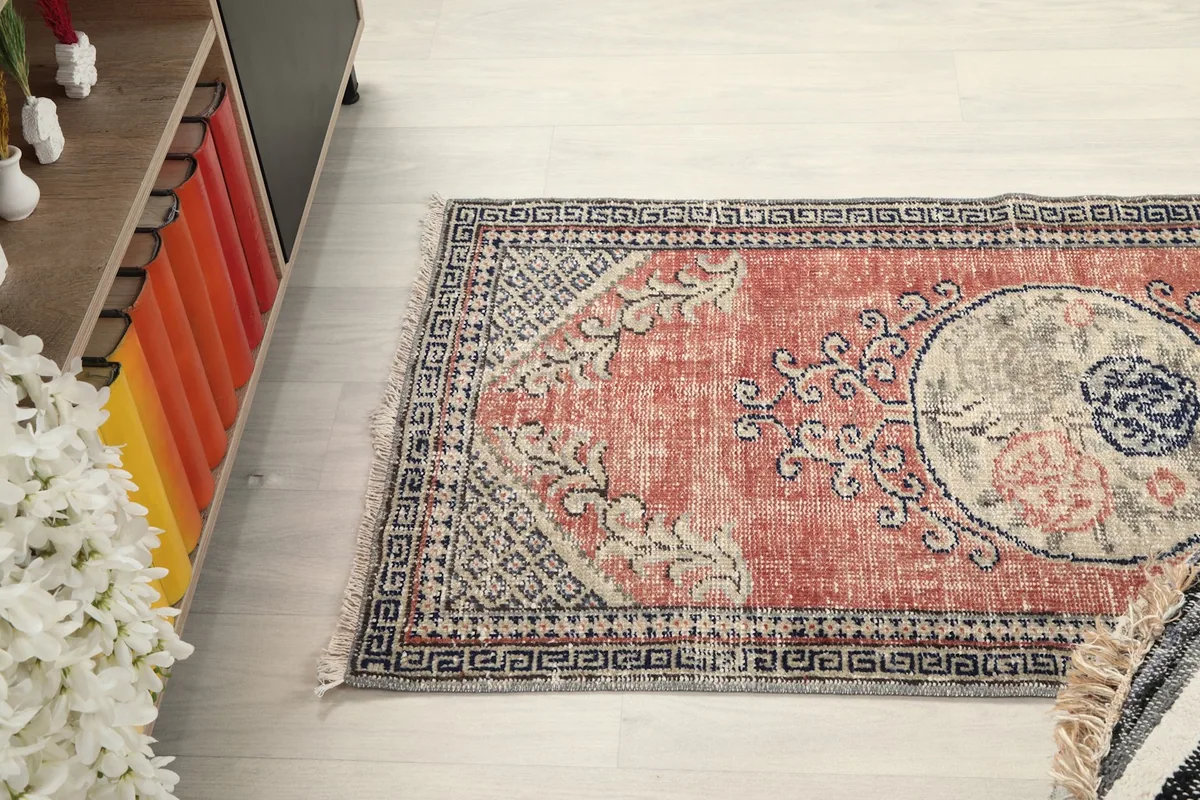 Overhead view of the rug in a room setting, showing its placement near a cabinet.