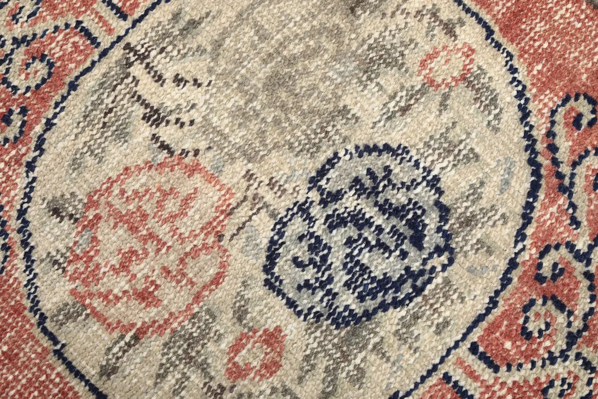 Macro shot of the wool pile, highlighting the texture and colors within the medallion design.