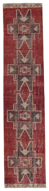 Full top view of the vintage Anatolian runner rug with red, charcoal, and tan geometric patterns