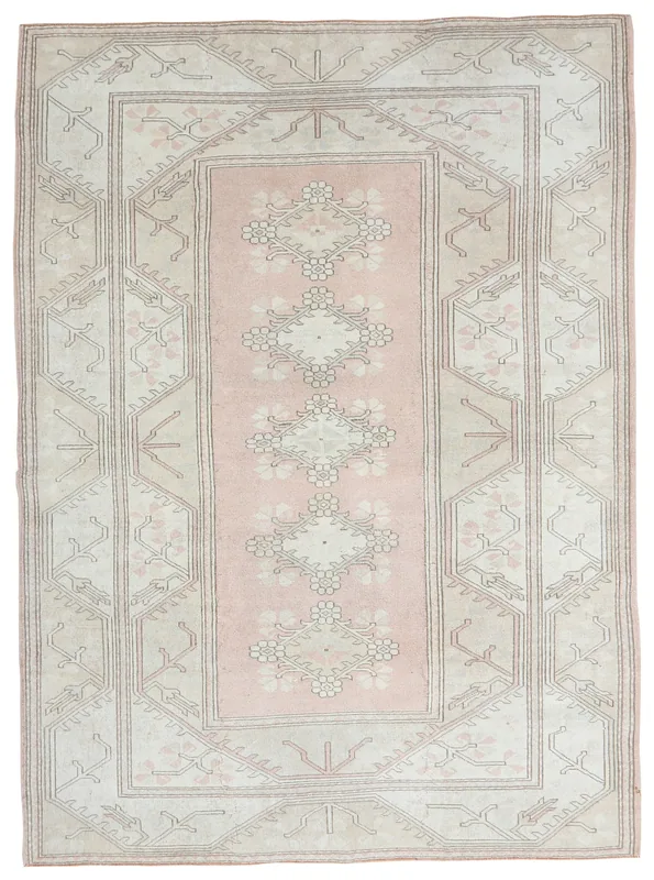 Full overhead view of the vintage pink and beige Anatolian area rug