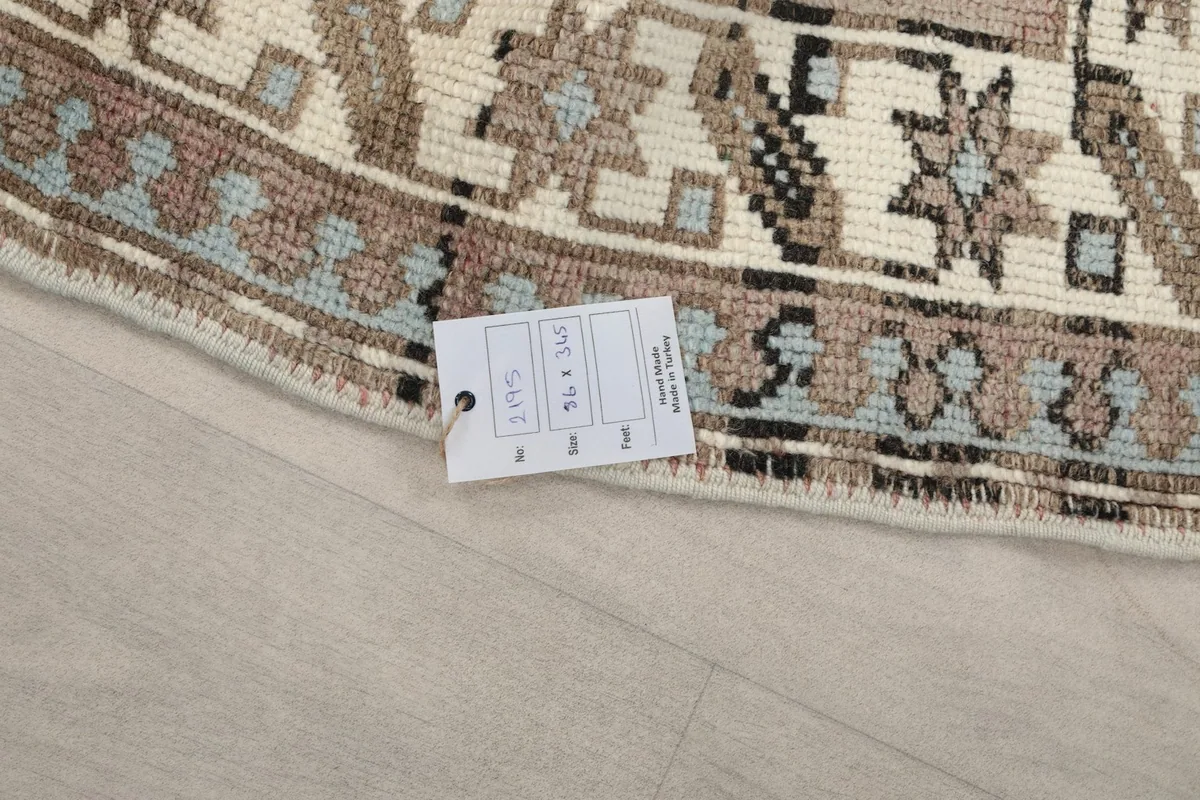 Close-up of the rug's label with size and item number details, next to the fringe