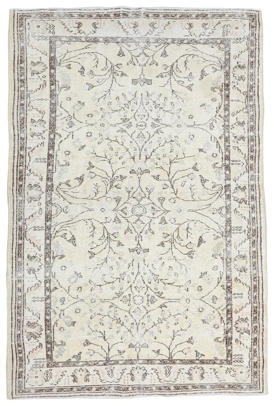 Full overhead view of the ivory and brown floral Anatolian vintage rug on a white background