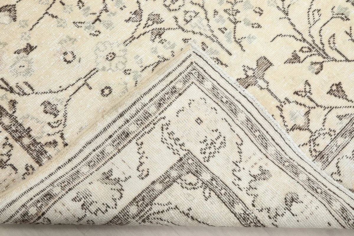 Underside of the rug, showing the hand-knotted cotton foundation and wool pile construction