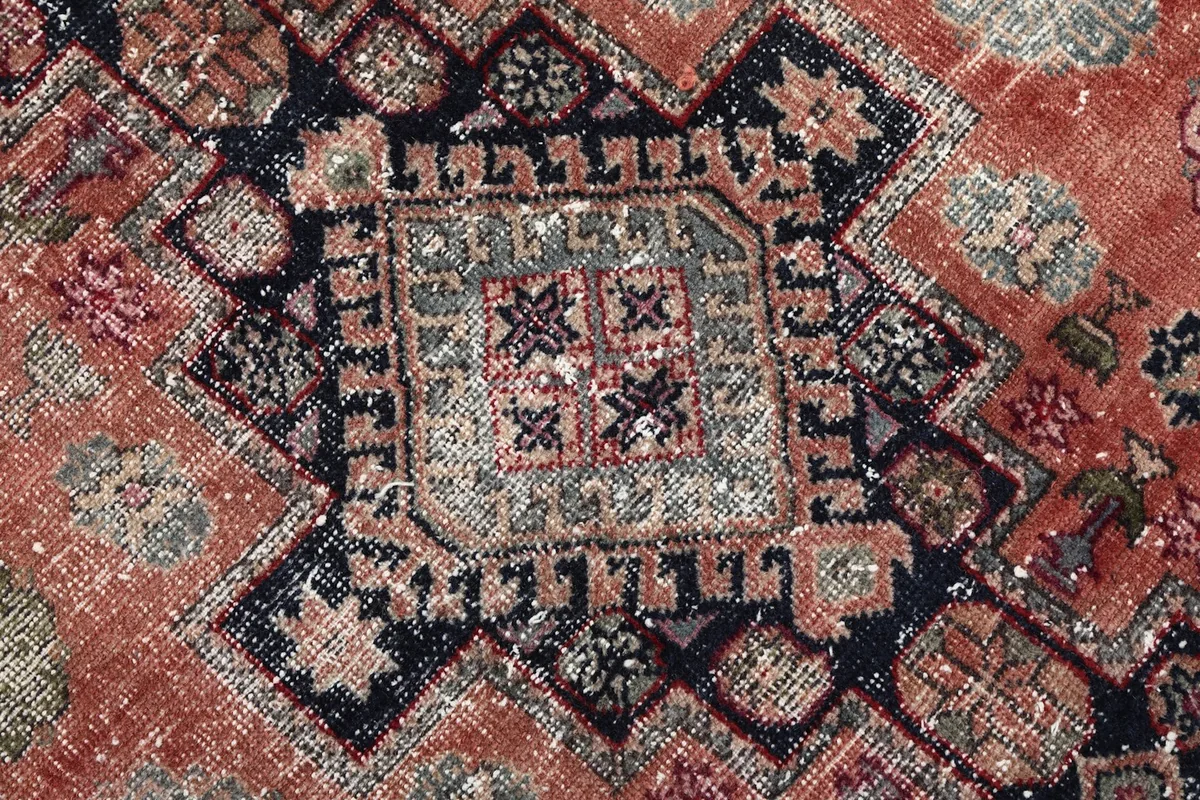 Detailed close-up of a main geometric medallion, showing the hand-knotted texture and color variations.