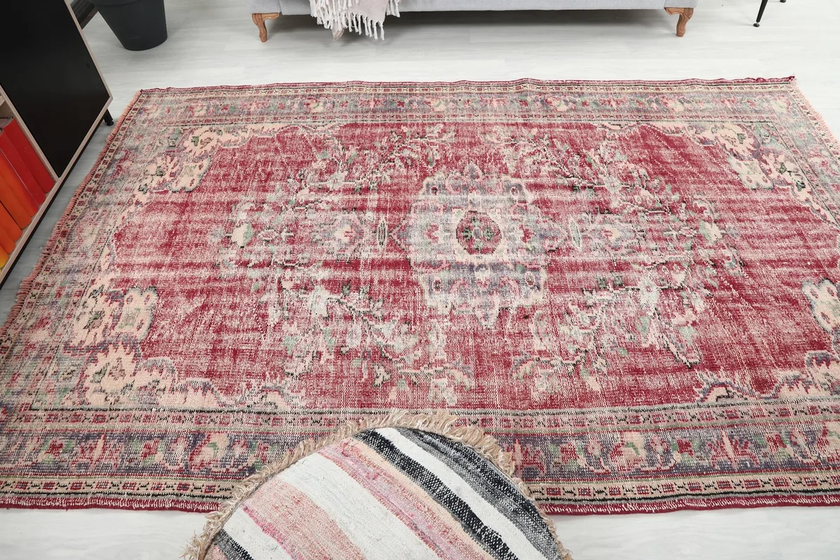 Overhead shot of the full rug, showing the consistent pattern and distressed appearance across the surface.