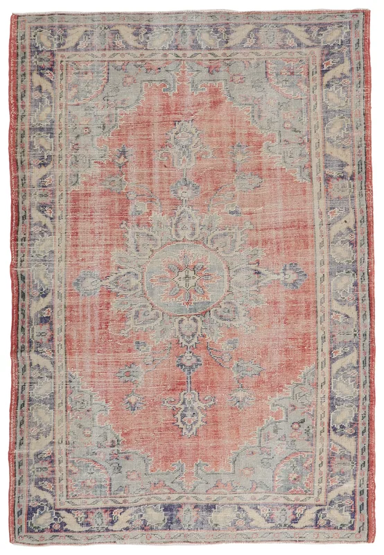 Full top view of the vintage rose and blue medallion Anatolian rug on a white background.