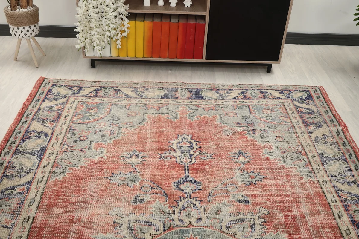 Overhead angle view of the vintage rug, highlighting the top half of the design.