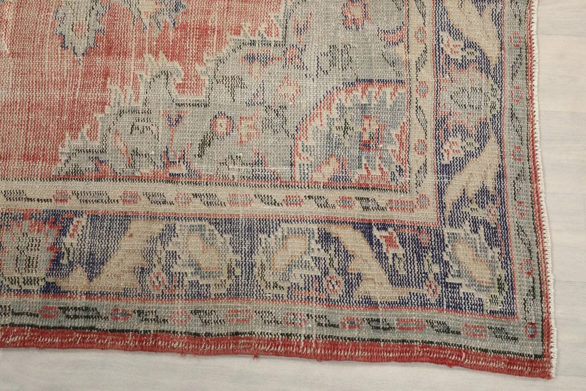 Detailed view of the outer border and corner of the rose and blue Anatolian rug.