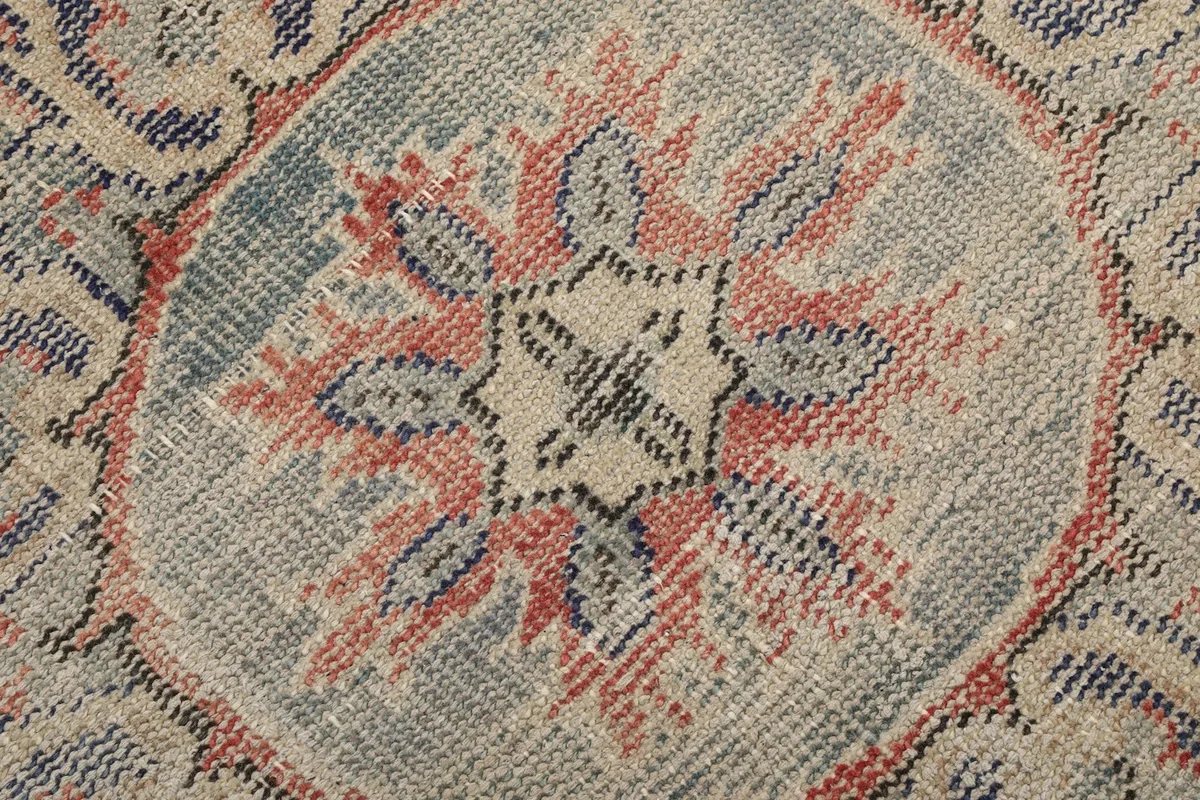 Macro detail of the hand-knotted wool pile, showing the intricate weave and color variations.
