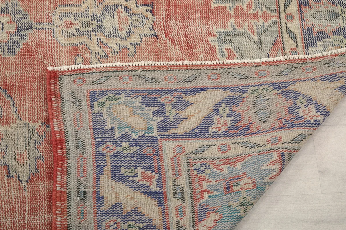 Another view of the rug's reverse side and foundation, showing the hand-knotted construction.