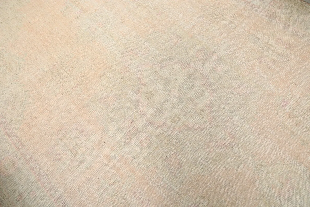 Close-up of the faded central field and medallion detail of the vintage rug