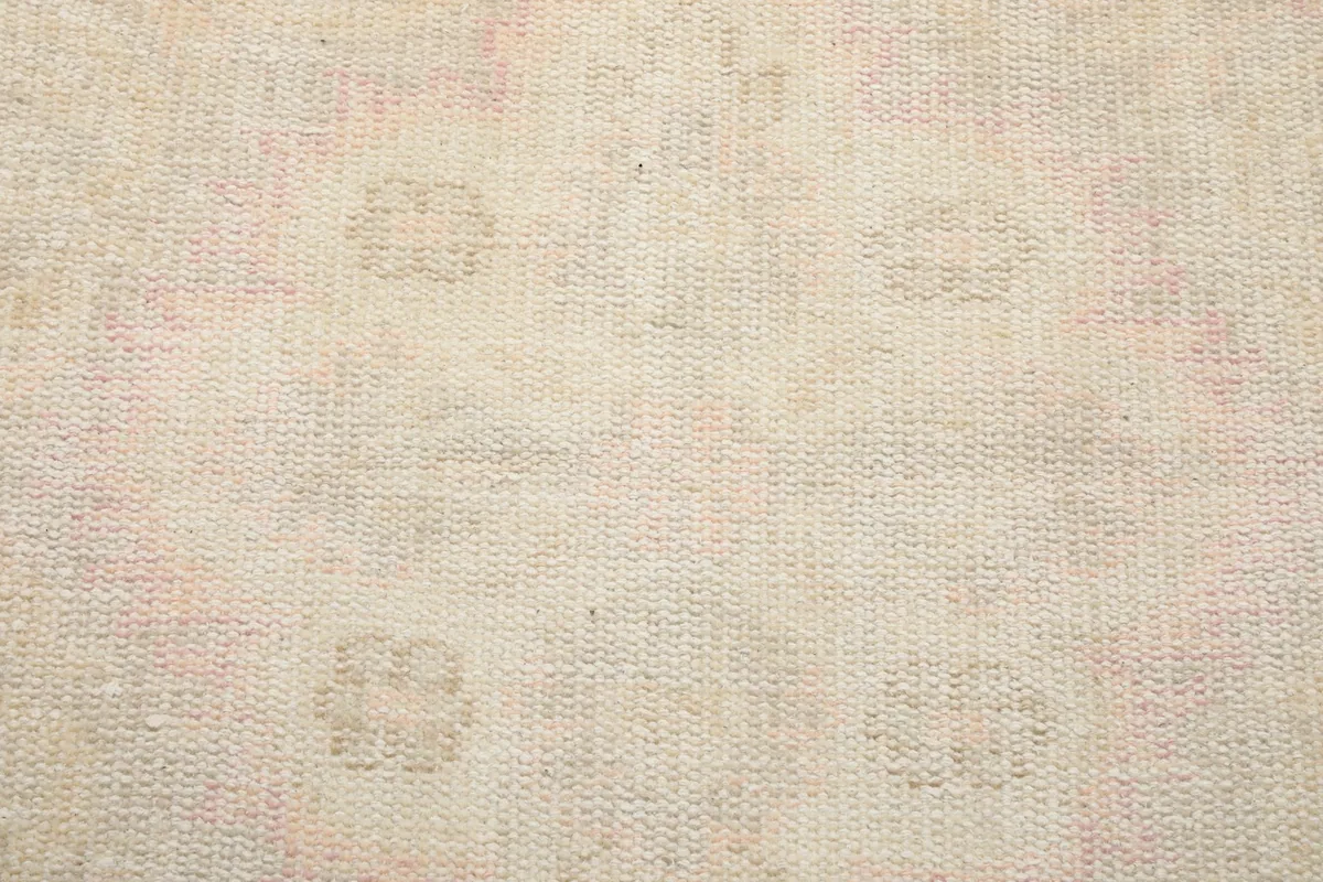 Extreme close-up showing the low wool pile and hand-knotted construction