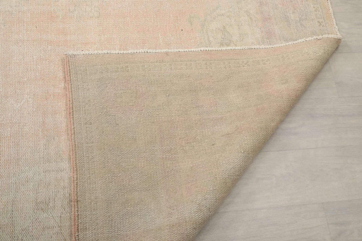 Folded corner of the rug revealing the reverse side and construction