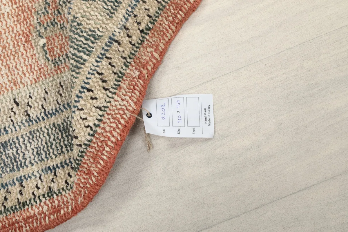 Care tag attached to the corner of the rug, displaying size and material information