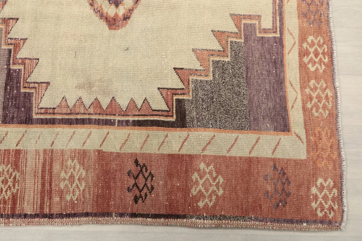 Detailed corner view of the rug's border and main field, highlighting the wool texture and hand-knotted quality.