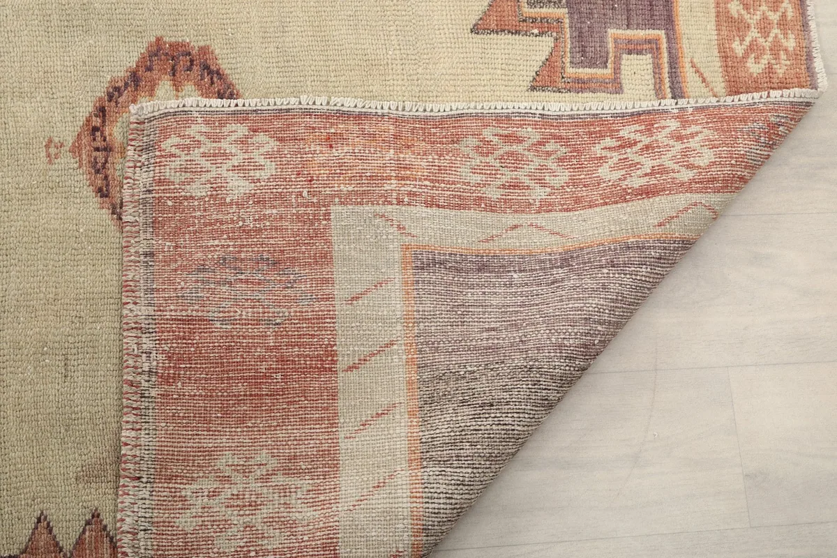 Close-up of the back of the rug, showing the tight knotting and the quality of the wool and cotton materials.