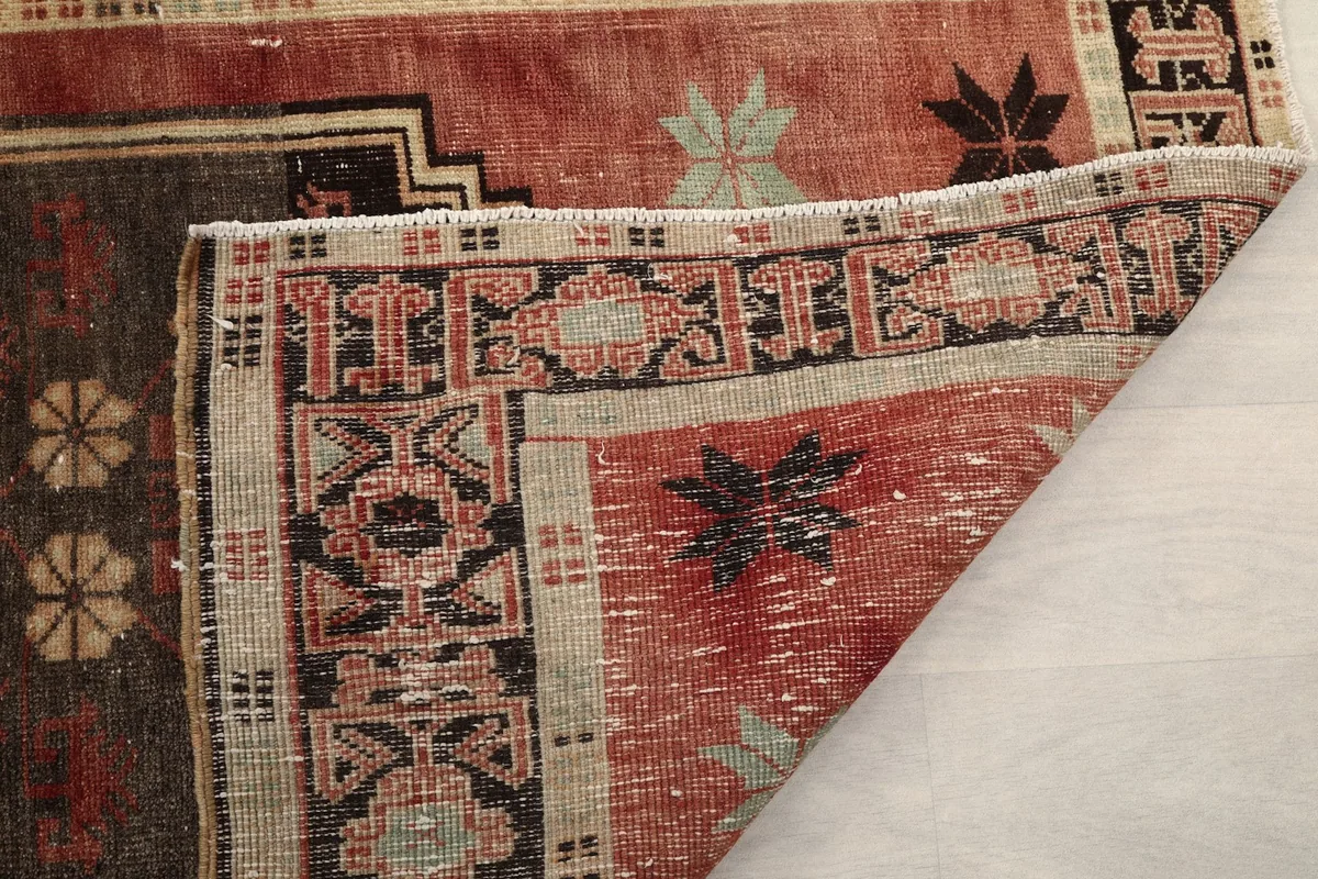 Another folded corner view, highlighting the hand-knotted construction and foundation