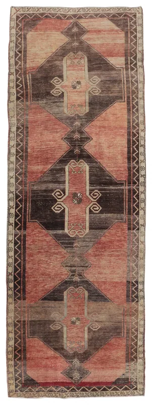 Full top view of a rust and brown vintage Anatolian runner rug with geometric patterns