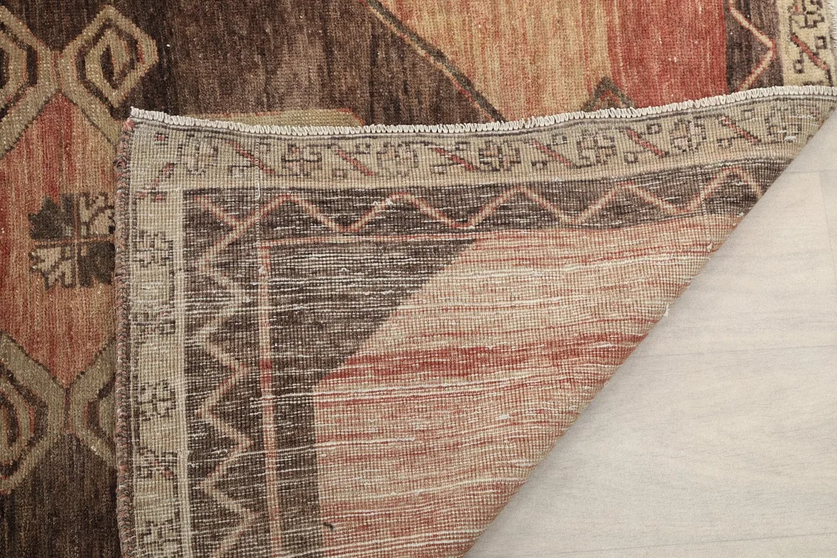 View of the rug's reverse side, revealing the dense knotting and cotton foundation