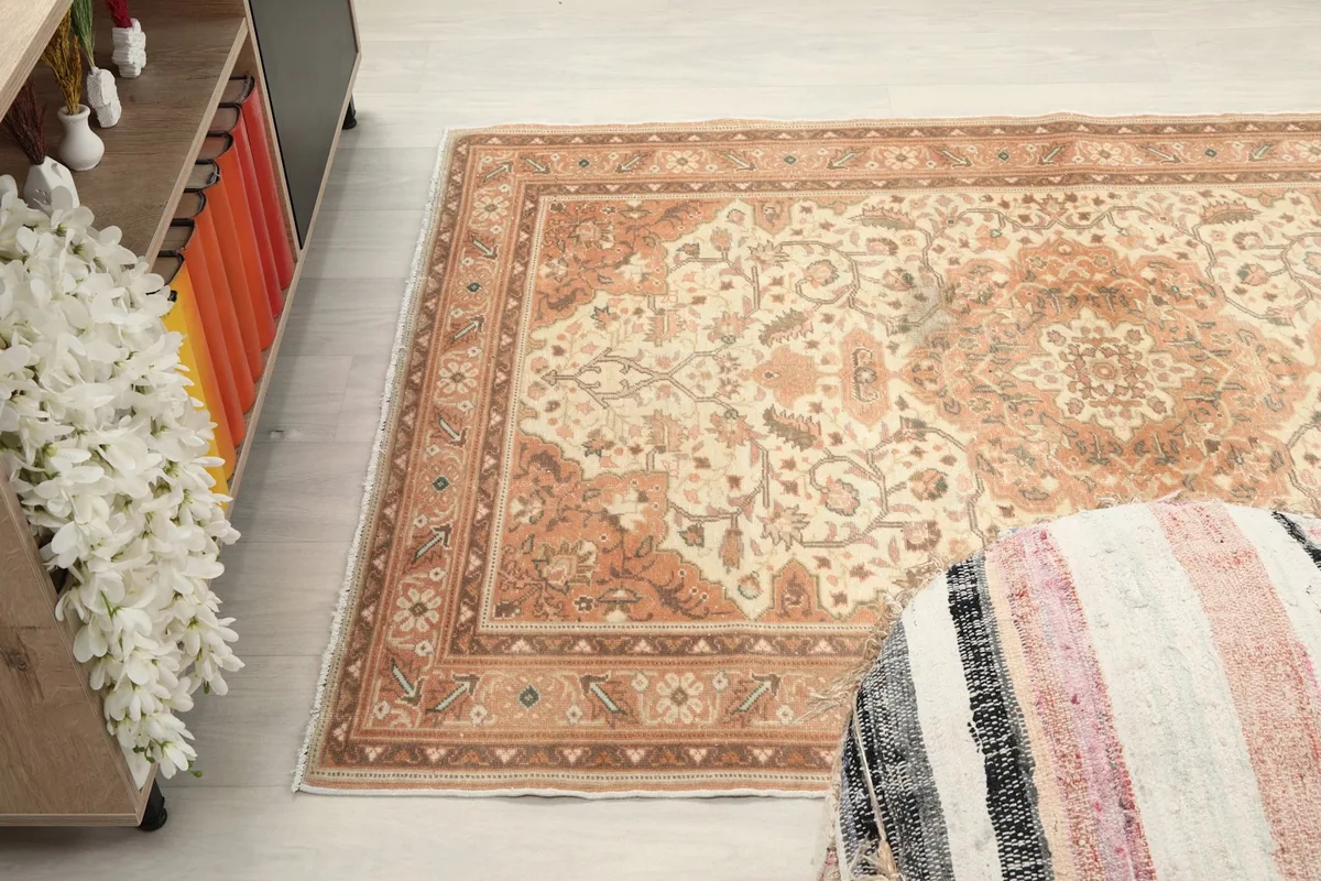 Wide-angle shot of the rug on the floor, capturing its overall pattern and color distribution.