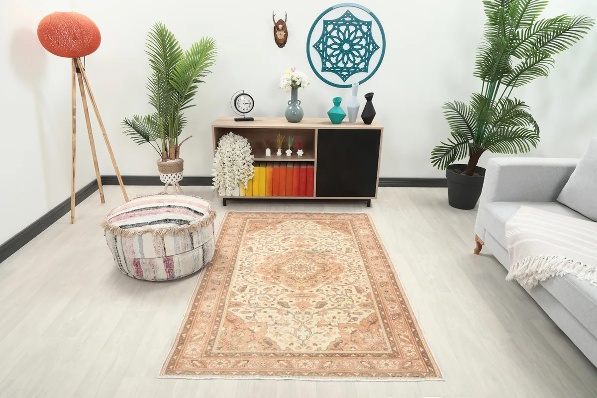 Vintage Anatolian rug displayed in a modern living room setting with light flooring.