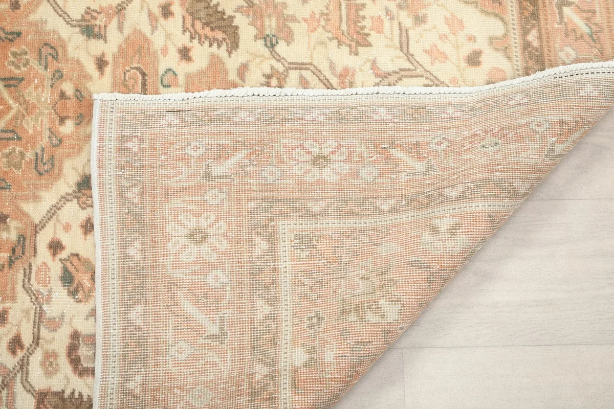 Underside of the rug's corner, showing the tightly woven cotton foundation and fringe.