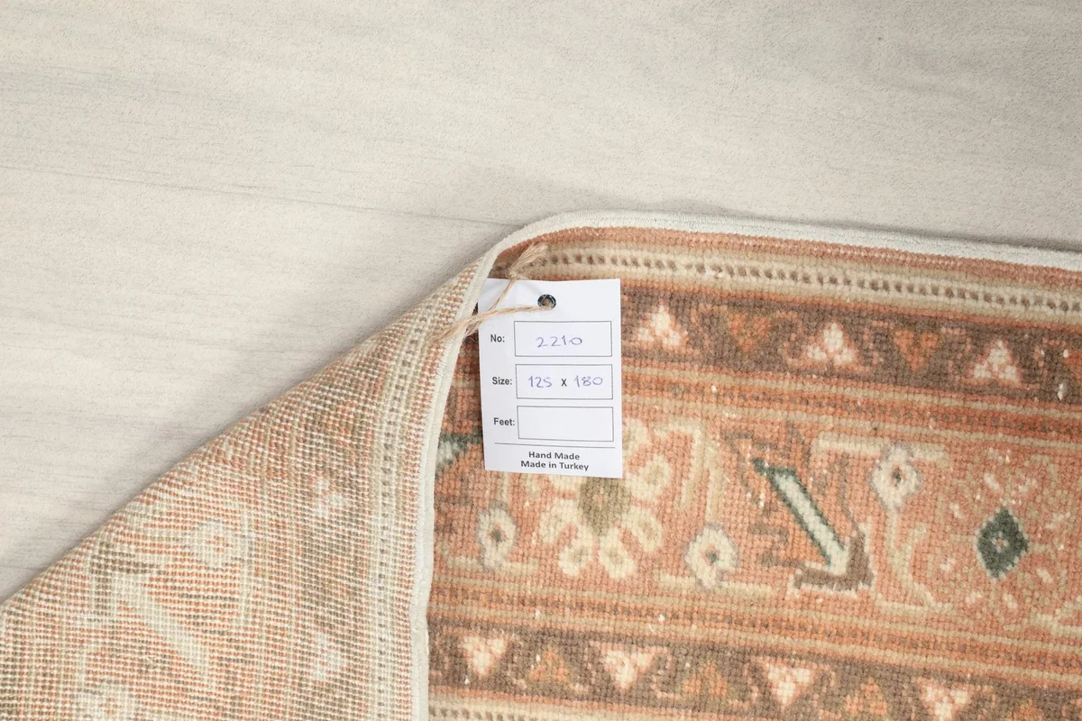 Close-up of the rug's label attached to the back, showing size and origin details.
