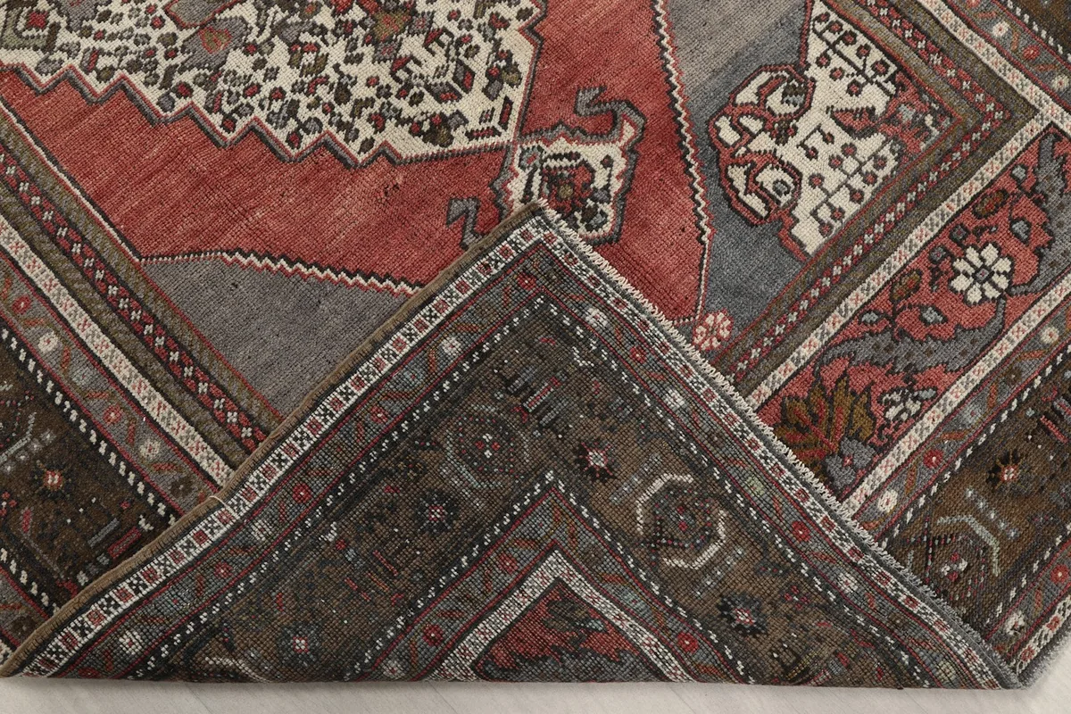Folded corner of the rug revealing the cotton foundation and reverse side