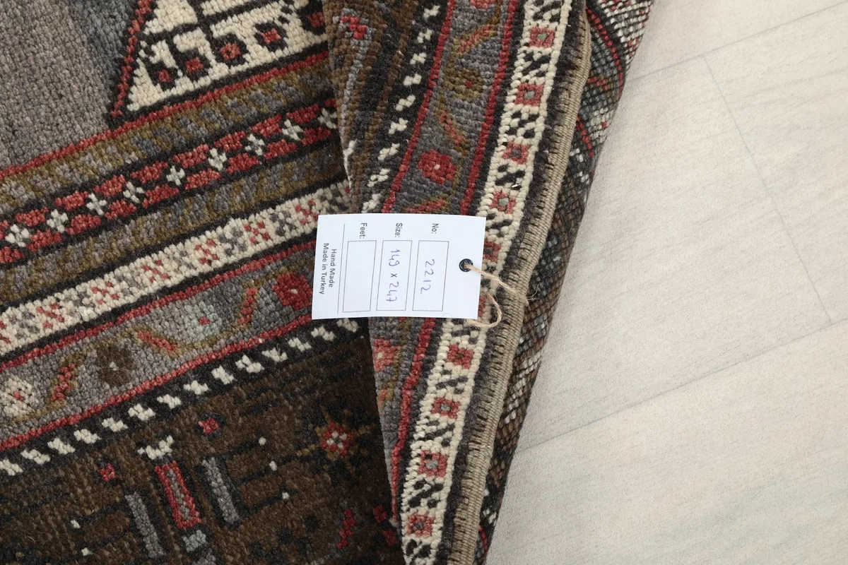 Product tag attached to the rug, showing size and origin details