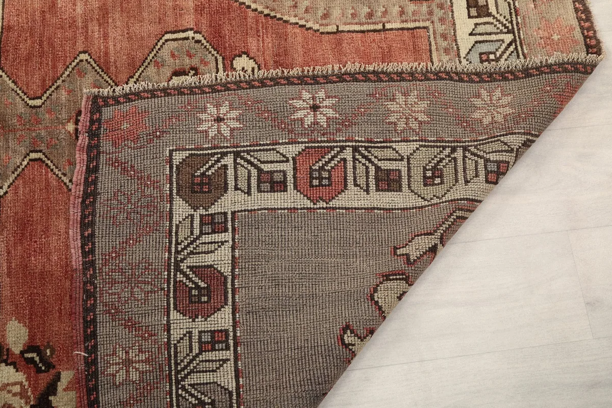 Another view of the rug's back, showcasing the tightly woven construction and short fringes