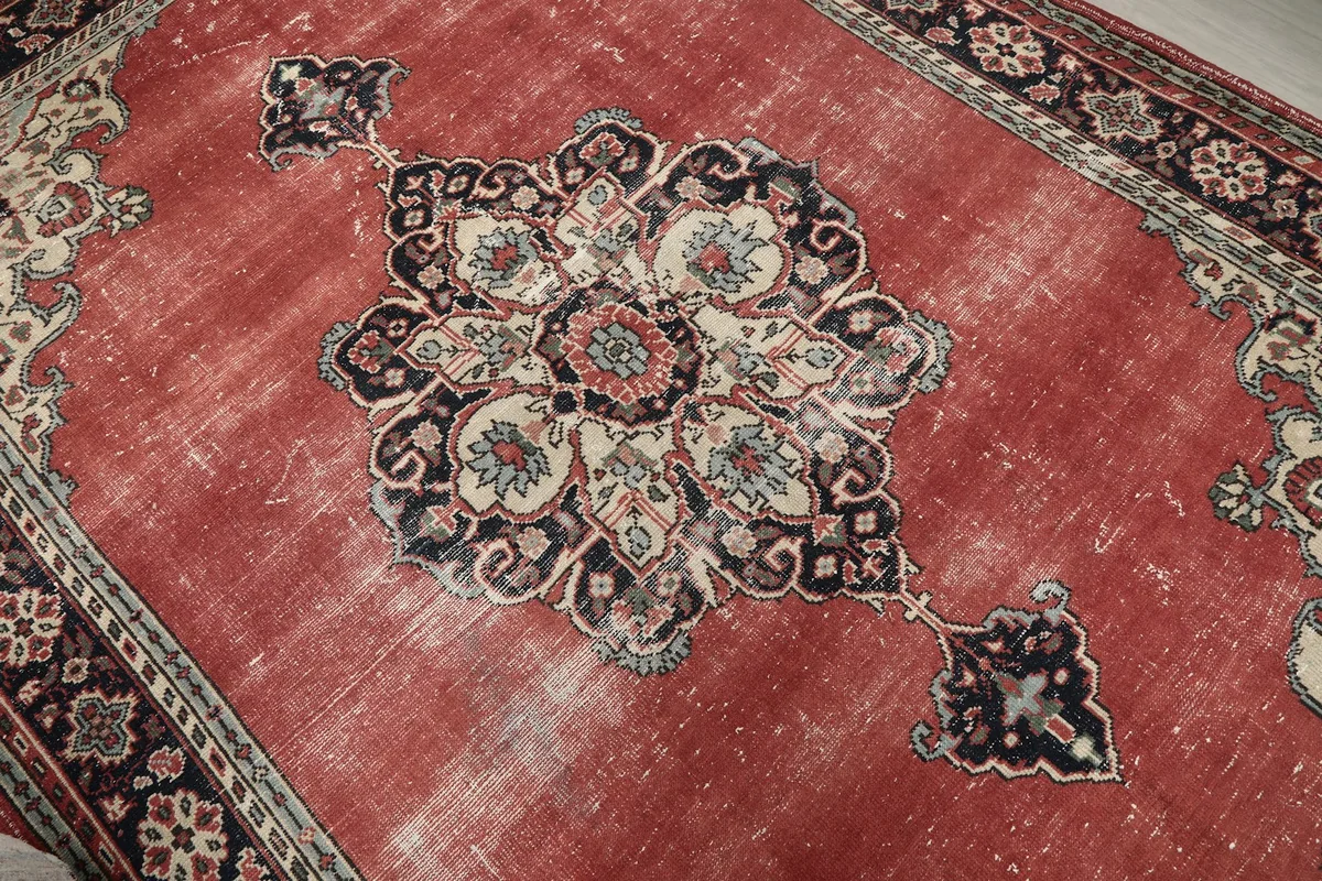 Close-up of the central navy, beige, and red medallion design and field texture