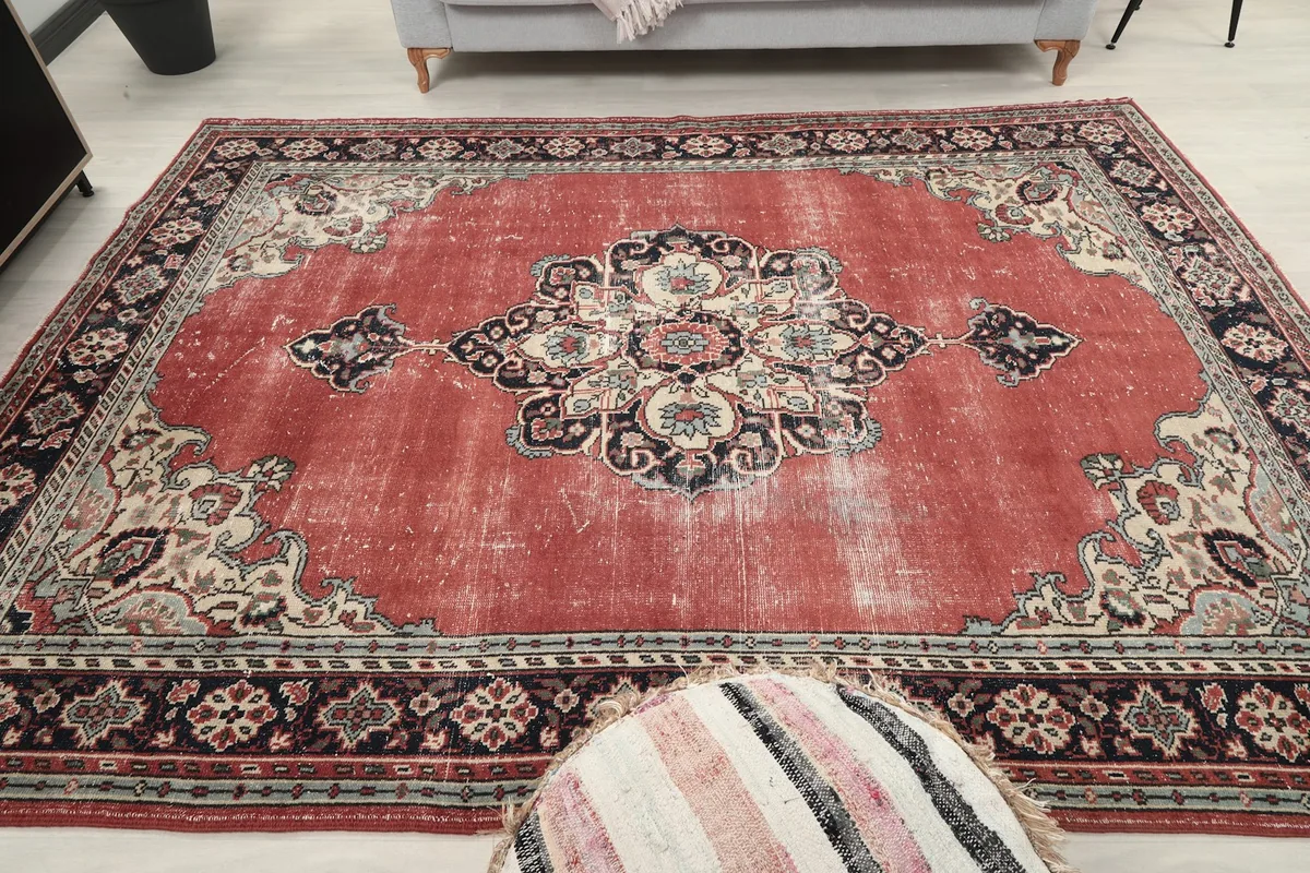 Full overhead view of the vintage red rug on the floor, showcasing its entire design