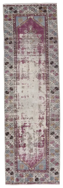 Full top view of the vintage Anatolian runner rug with rose and beige distressed field and geometric border