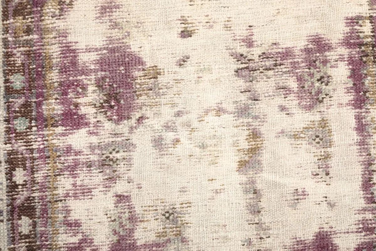 Close-up of the low pile and distressed areas, showing the wool pile on cotton foundation