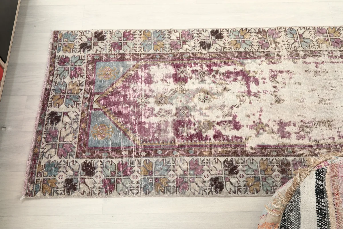 Overhead view of the runner rug, capturing the full pattern and faded rose field