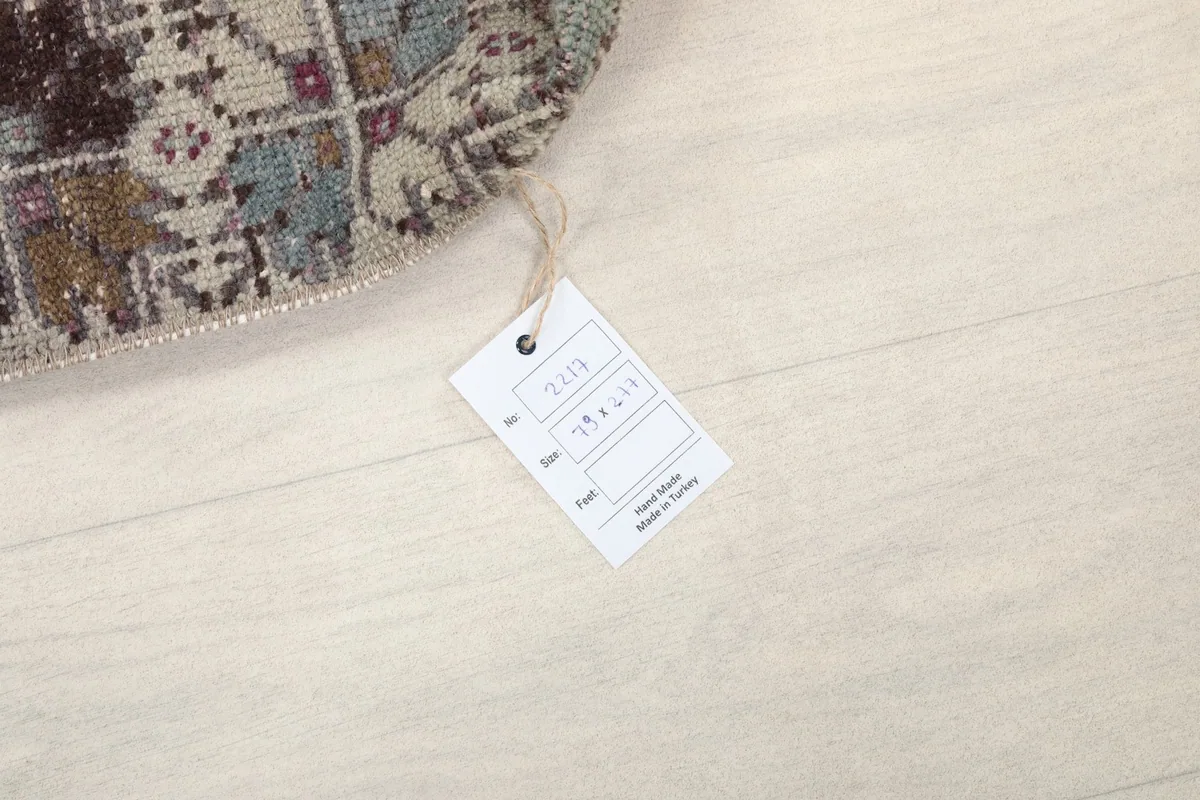 Close-up of the rug's edge with a product tag showing details like size and origin