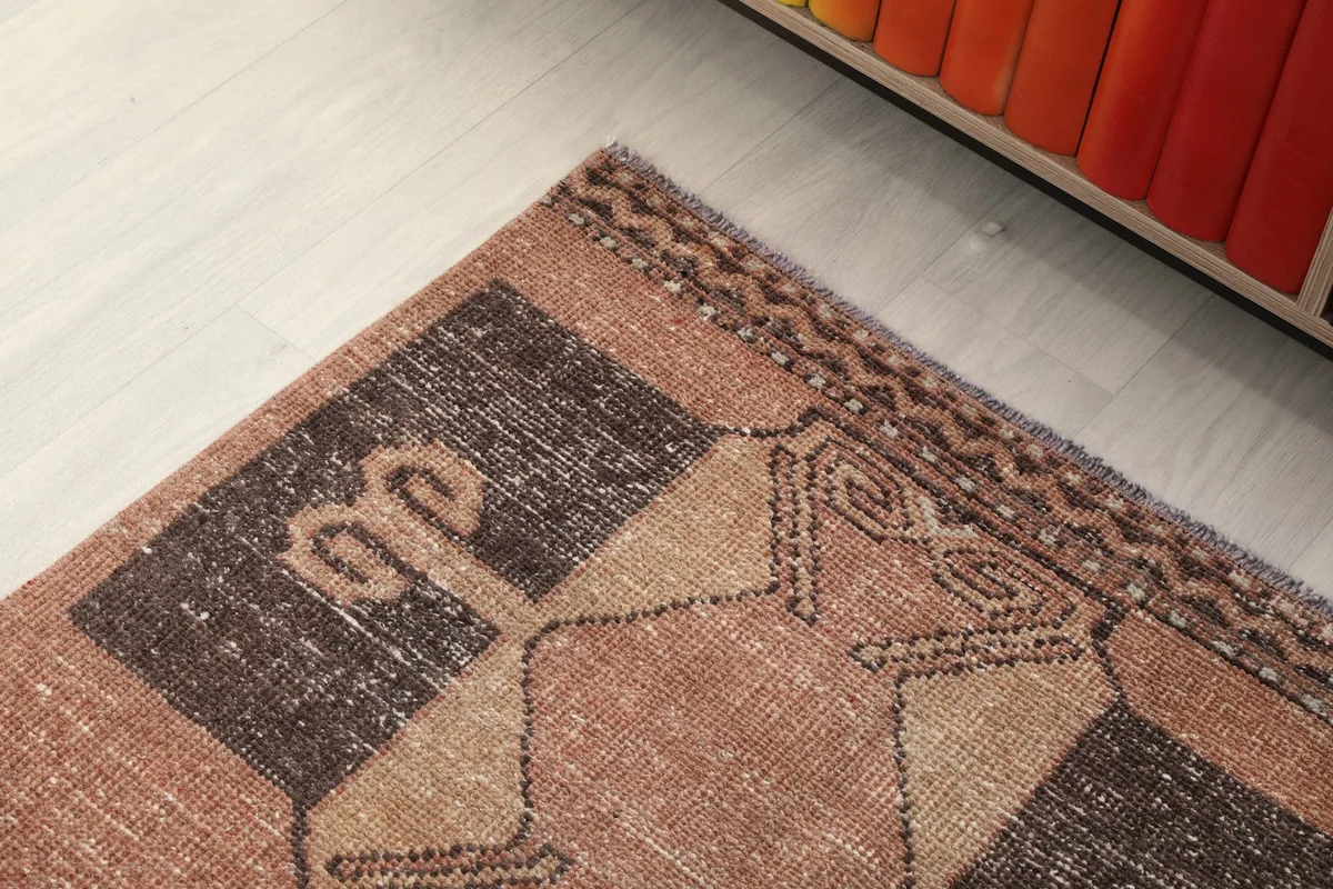 Corner detail of the runner rug, showing the intricate border and a section of the main design